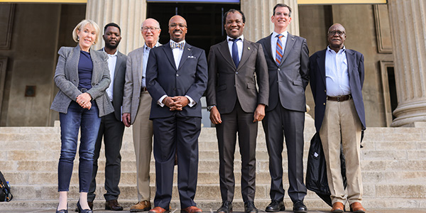 US Ambassador Reuben Brigety with Professor Zeblon Vilakazi and staff on the steps of the Great Hall